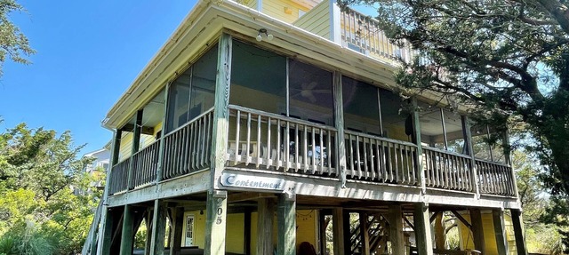 Contentment: Spacious home, den, screened porch, marsh views.