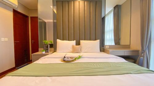 Spacious and Homey 2BR Apartment with Private Lift at The Kencana Residence By Travelio